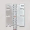 Uchwyty Sewtech TA3611/TA3612 do hafciarki Tajima – uchwyty od strony elementów mocujących.